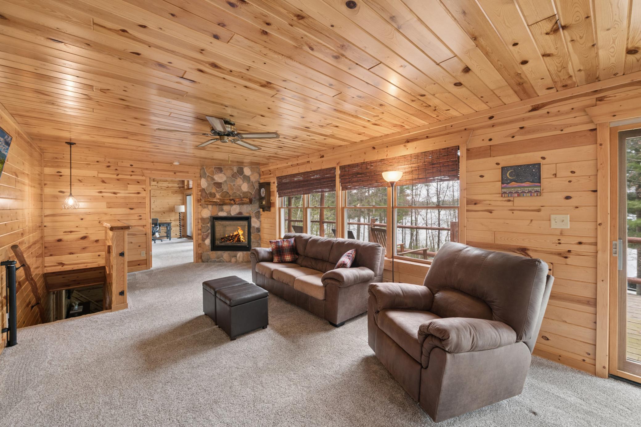 The upper level with the gas fireplace and a living room area that is cozy. Check out the woodwork for that up north look!