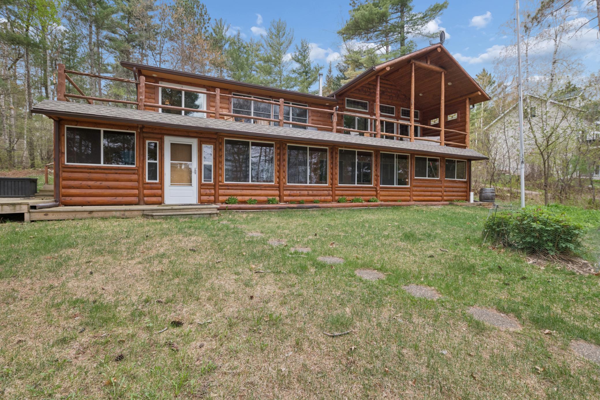 This large home with log siding overlooks the lake!
