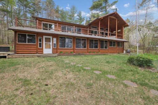 This large home with log siding overlooks the lake!