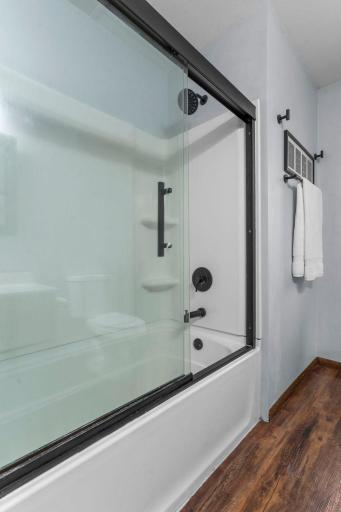 The bathroom was finished with a deep soaking tub and new glass doors.