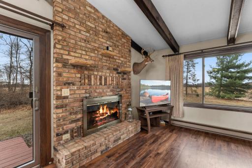 Home features 2 wood burning fireplaces. This one sits on the main level in the living room.