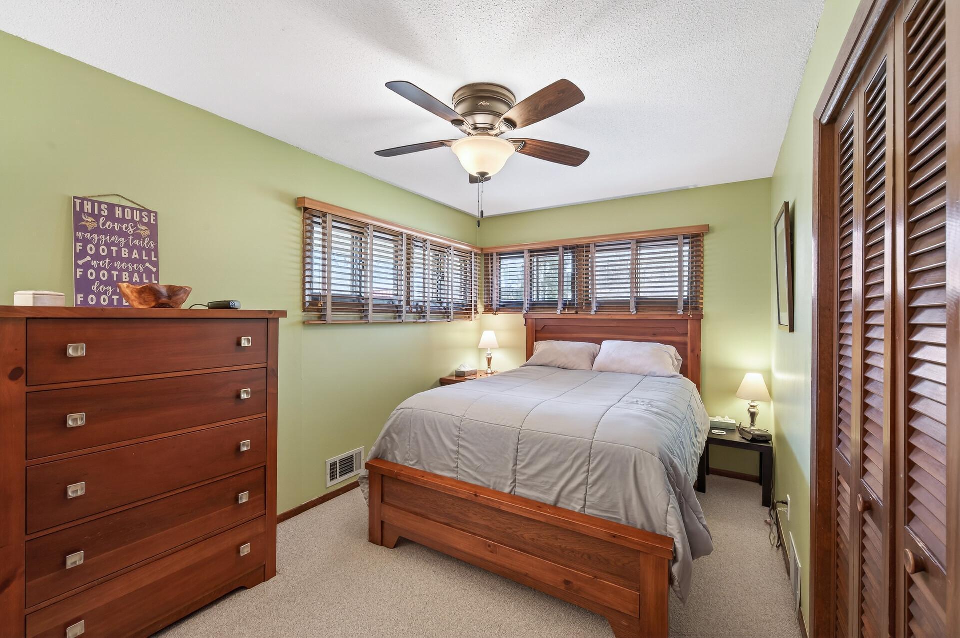 Main level primary bedroom with corner style windows.