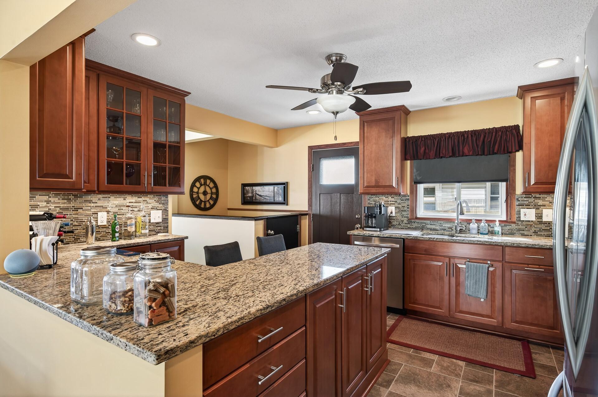 Open eat-in kitchen with granite counters.