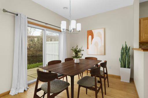 Dining room with new Anderson sliding door to the patio and pond views - virtually staged