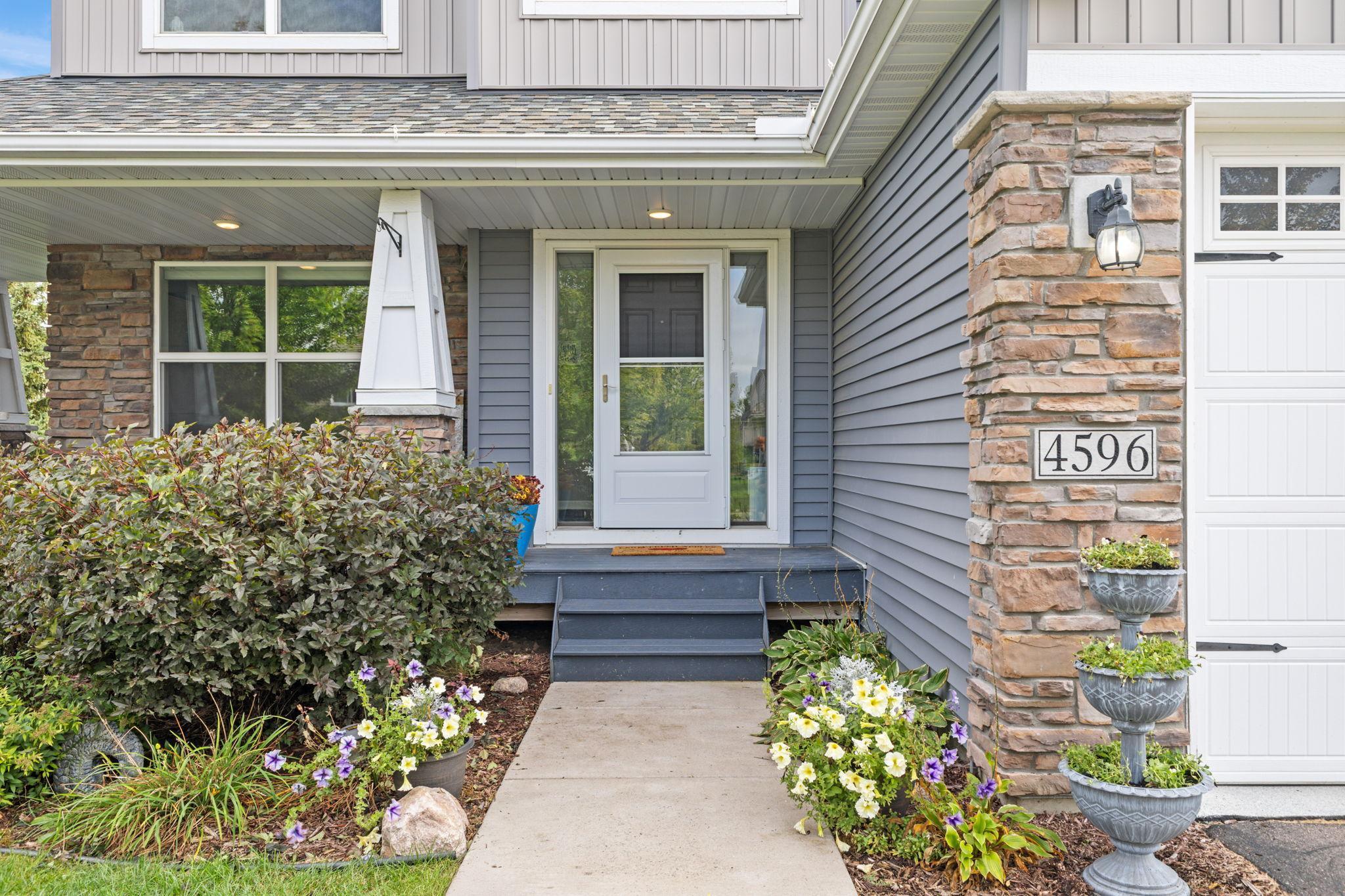 Enjoy low-maintenance landscaping and a front porch that invites you to sit and stay awhile. Stone accents add texture and charm, paired with durable vinyl siding for easy exterior care.