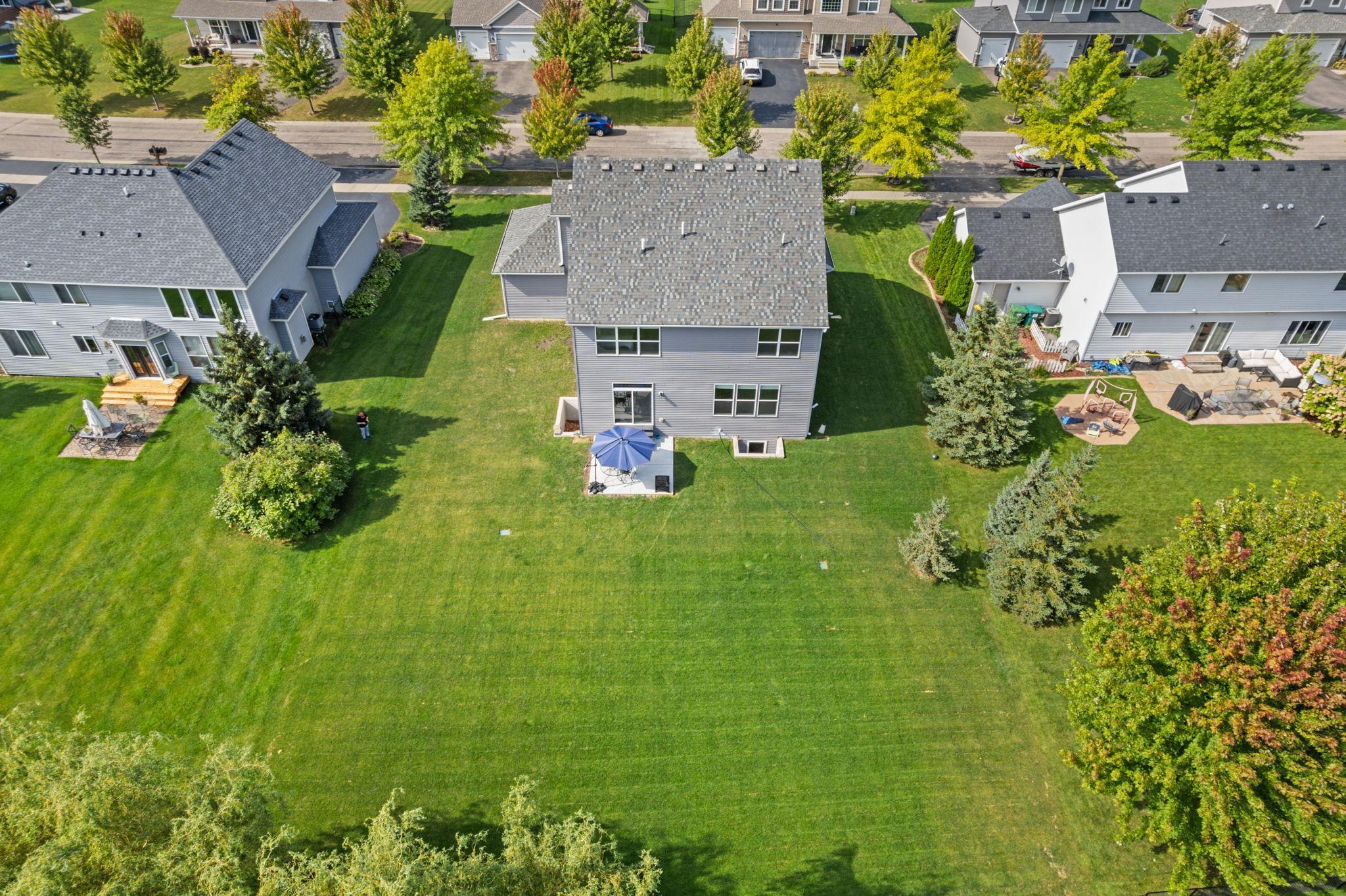 The east-facing backyard brings in warm morning light, creating a bright start to the day. Patio doors open directly into the dining area and kitchen, with the main-level living room seamlessly connected just to the right.