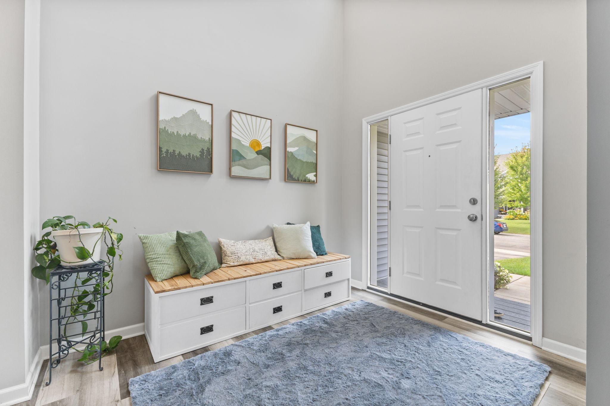 Step into a bright, two-story foyer with an open landing above that makes the whole space feel light and connected. Just off the entry is a main-level office, perfect for working from home or a quiet flex space.