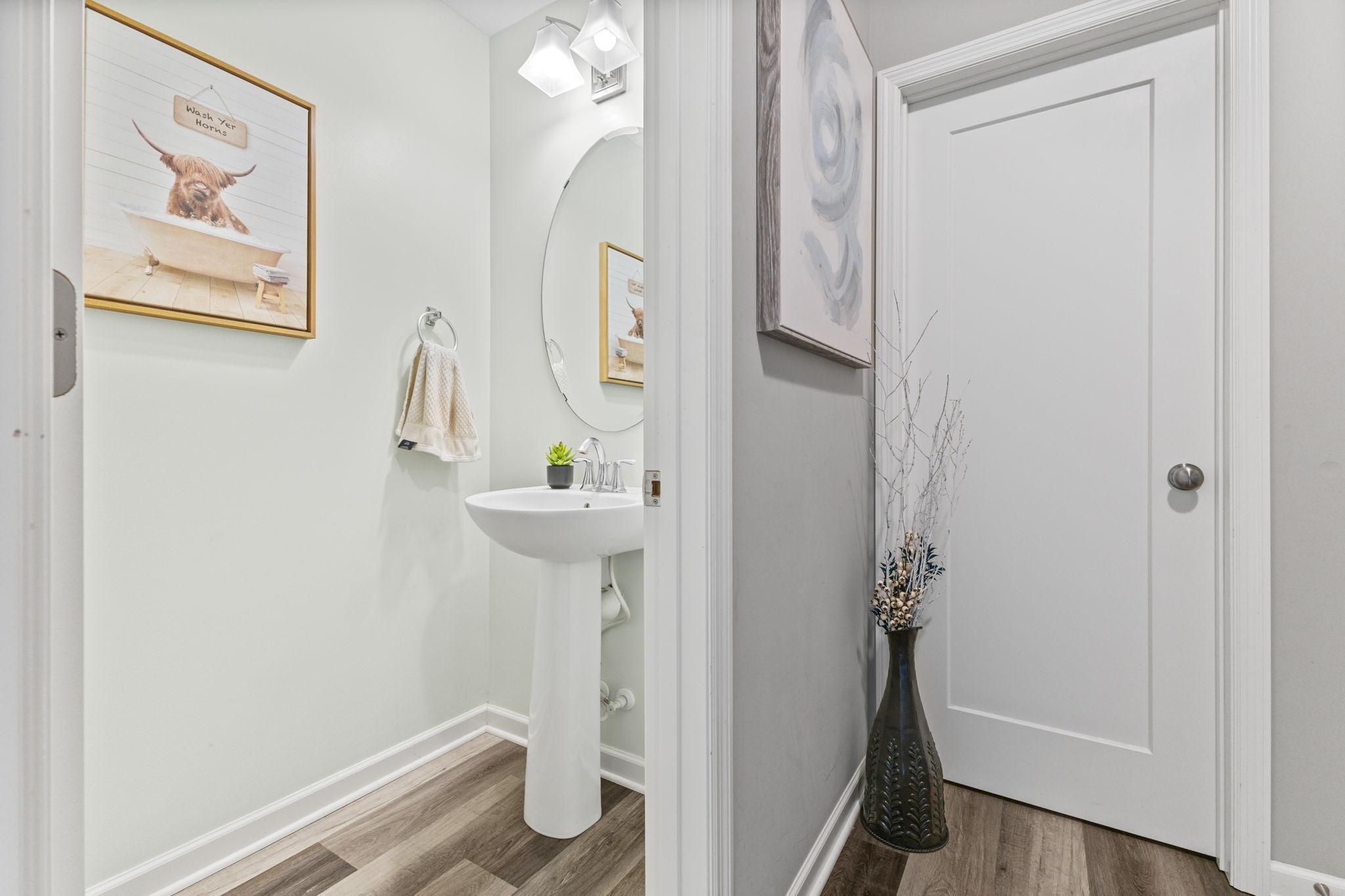 Convenient 1/2 bath located off the mudroom, along with a large walk-in closet offering excellent storage for everyday organization.