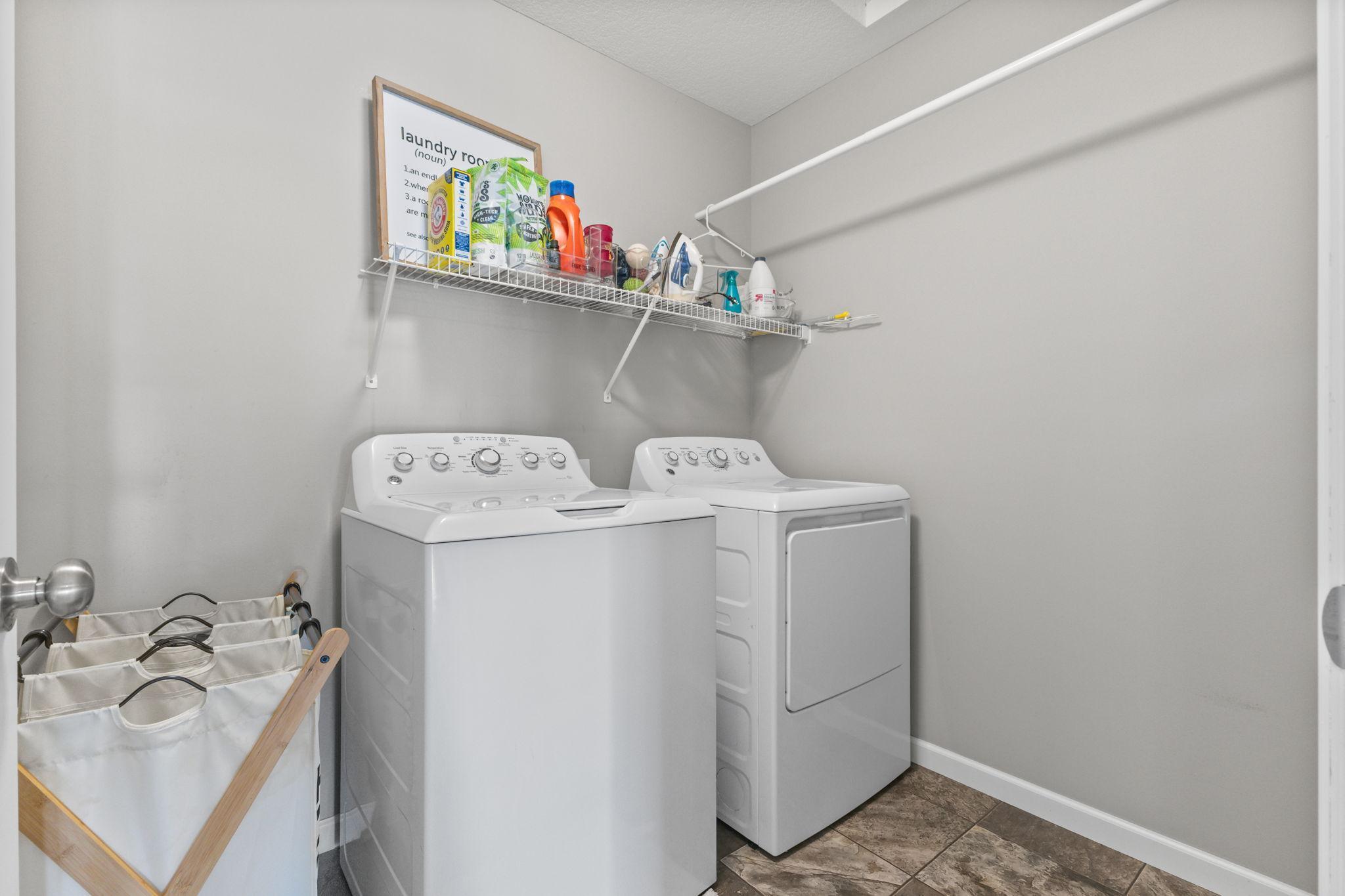 Convenient upper-level laundry with additional shelving for storage, making everyday routines simple and efficient right where you need it.