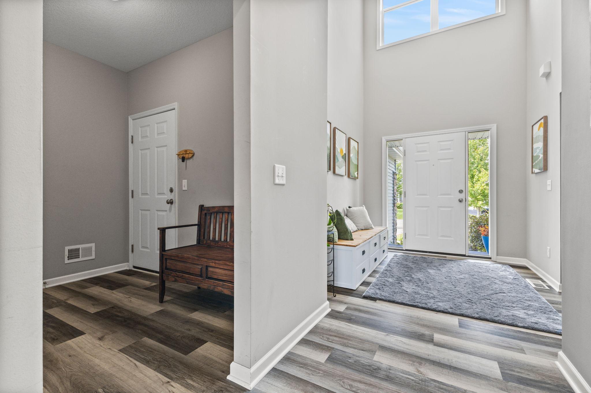 Front entry with a practical drop zone setup, connected to a mudroom featuring a walk-in closet for added storage. Easy access to a 1/2 bath and garage keeps everyday organization simple and efficient.