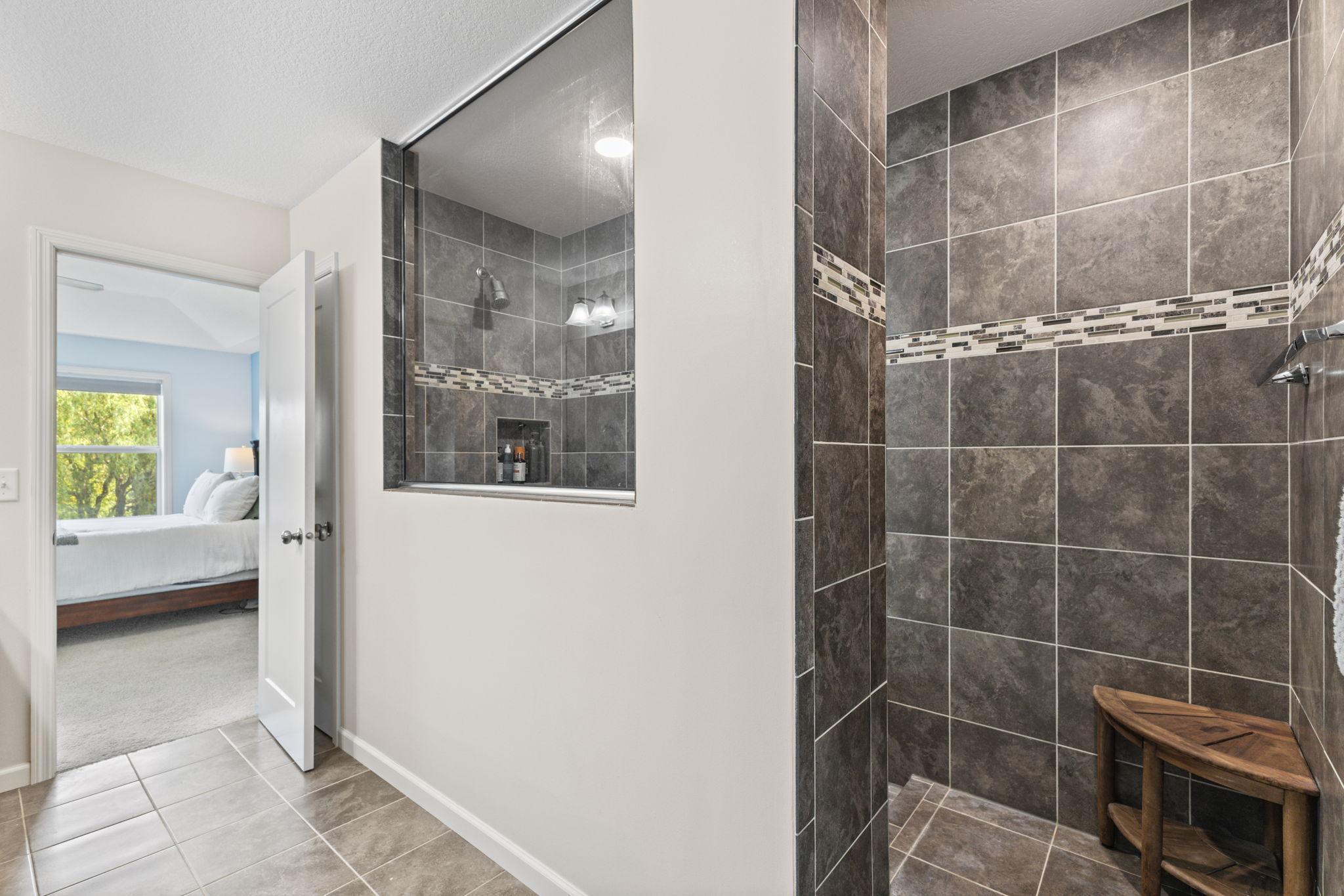 Spacious walk-in shower with full tile surround and a built-in niche, creating a clean, modern look. The size and layout offer a comfortable, spa-like feel.