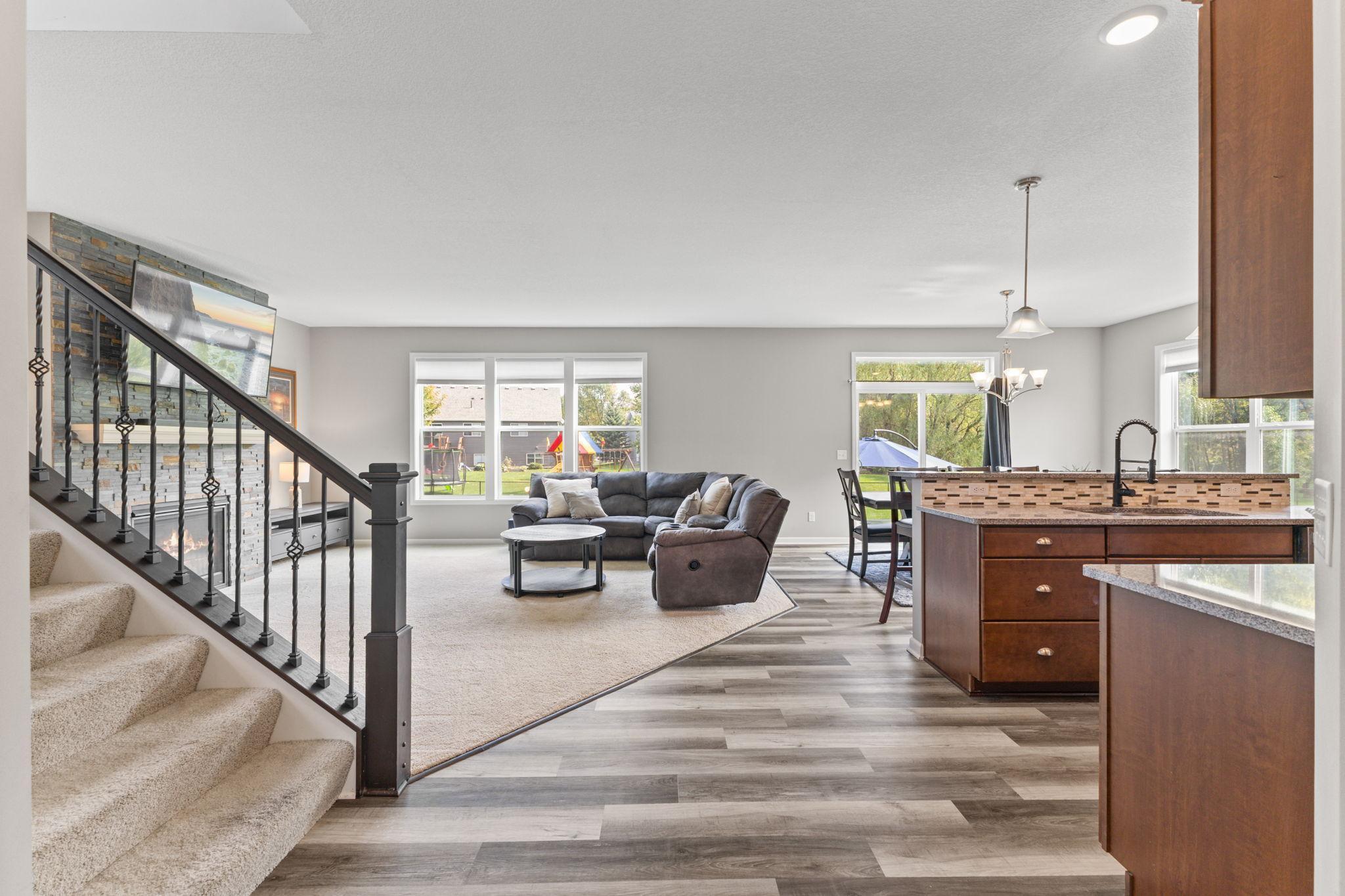 The foyer leads into an open main level where the living room, kitchen, and dining area flow together-overlooking the backyard and patio.