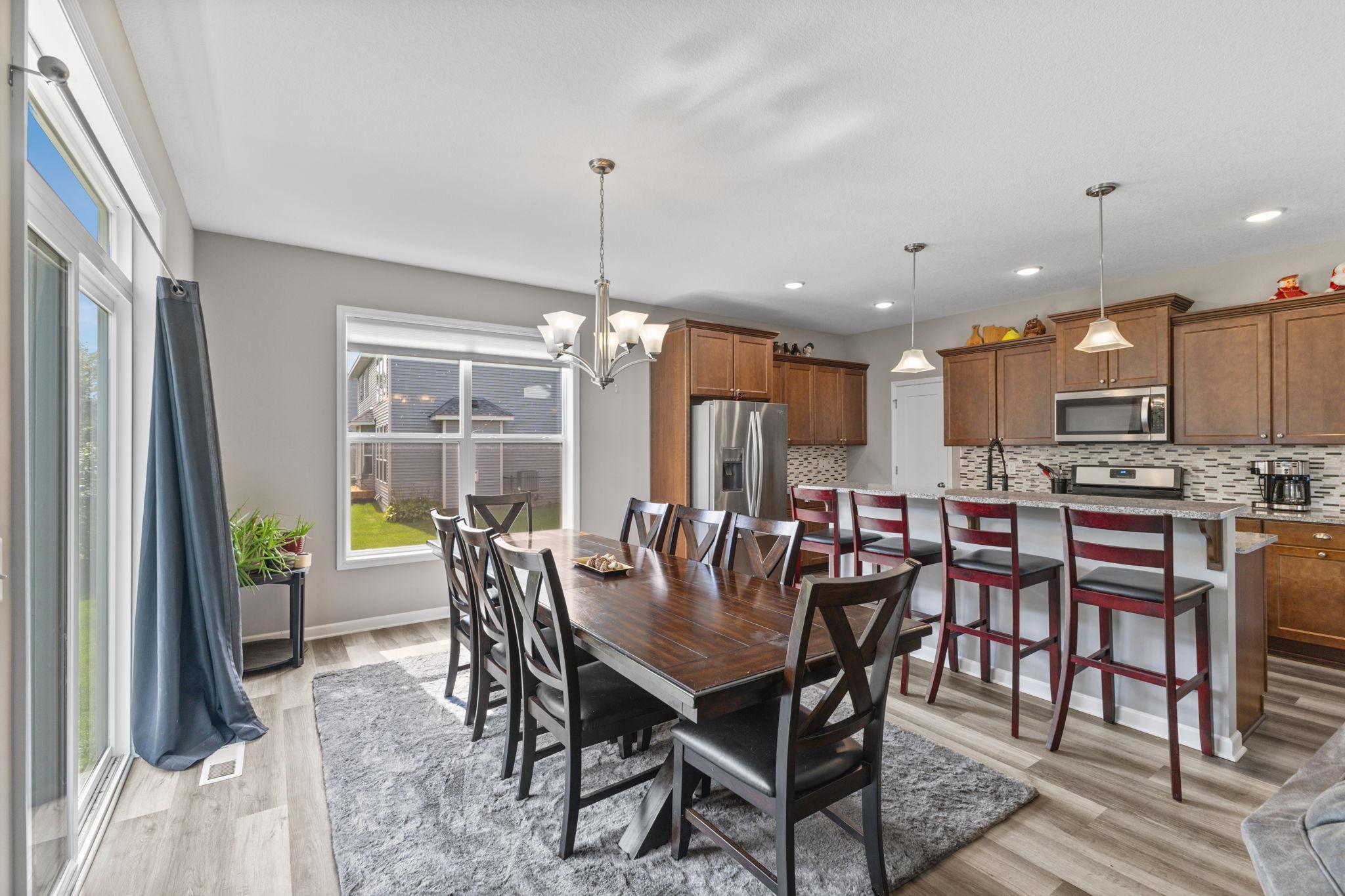 Generous dining area with plenty of room for a full-size table and additional seating, ideal for everyday meals or hosting. Positioned off the kitchen with easy access to the backyard, creating a functional and comfortable gathering space.