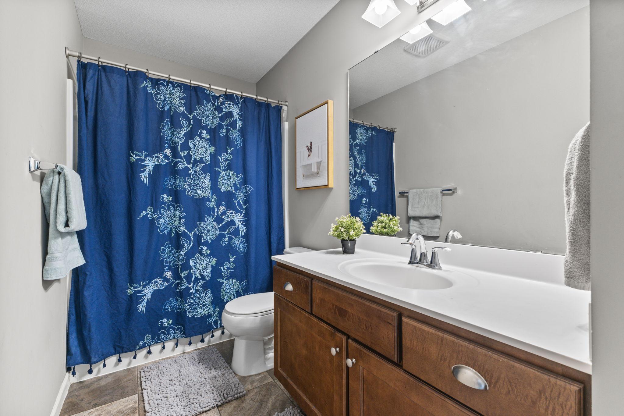 Upper-level full bath with a large vanity and a full storage closet, offering plenty of space to keep everything organized and out of sight.