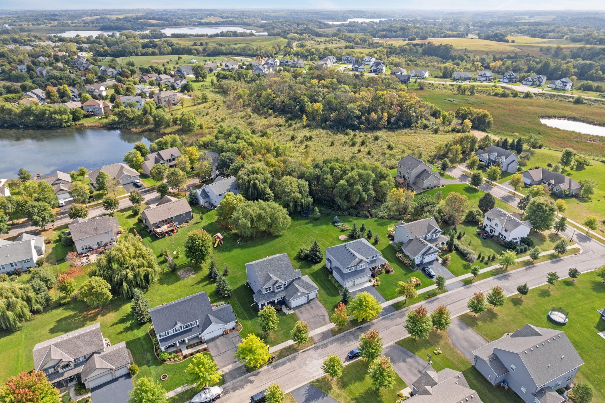 Surrounded by expansive green space and natural landscape, the setting offers a peaceful, open feel with scenic views in every direction, creating a sense of privacy while still being part of a connected neighborhood.