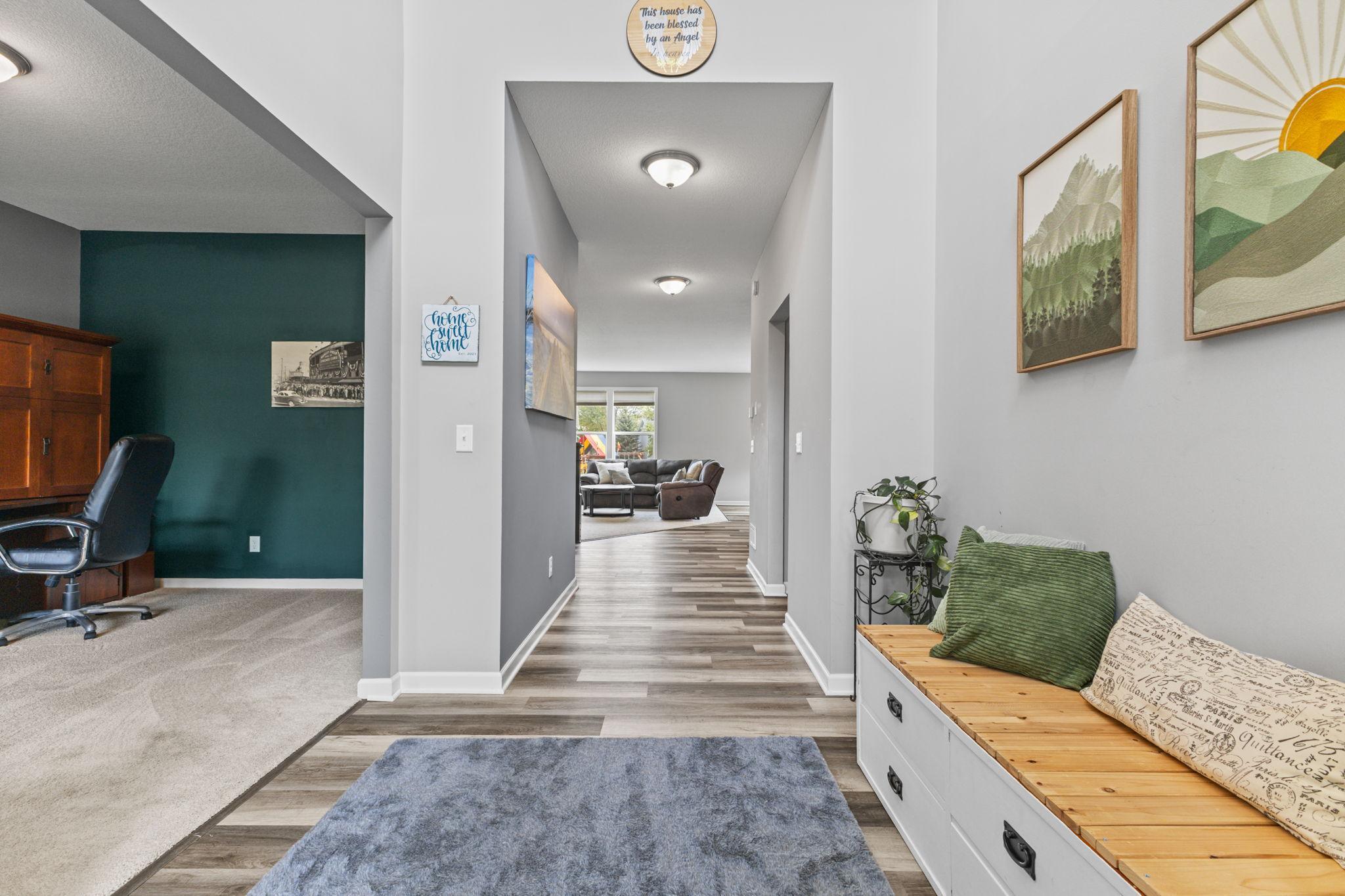 Bright two-story entry with fresh paint and clean flooring. Off the foyer, a flexible space, currently a home office, can serve as a den, playroom, or a music room! Nearby are a 1/2 bath, mudroom, and access to the garage.