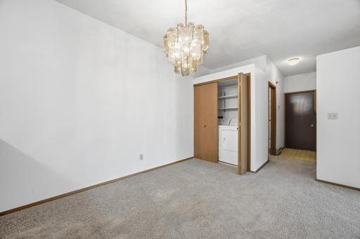 Back hallway has entry to garage, coat closet, and main bathroom