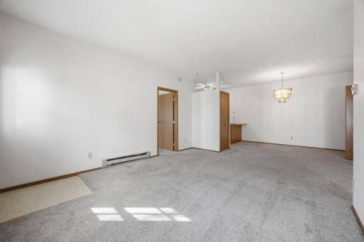 Living room looking toward primary bedroom and kitchen
