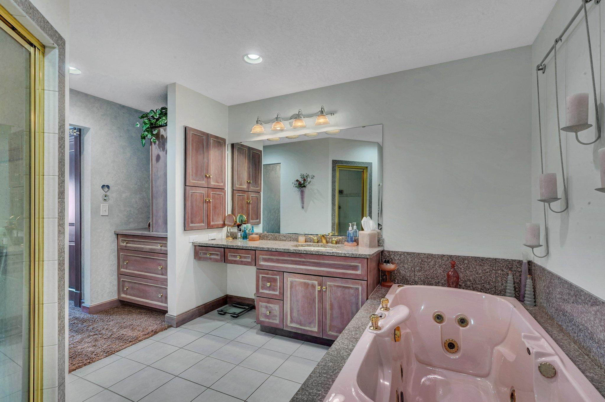 Primary bathroom with separate shower and soaking tub.