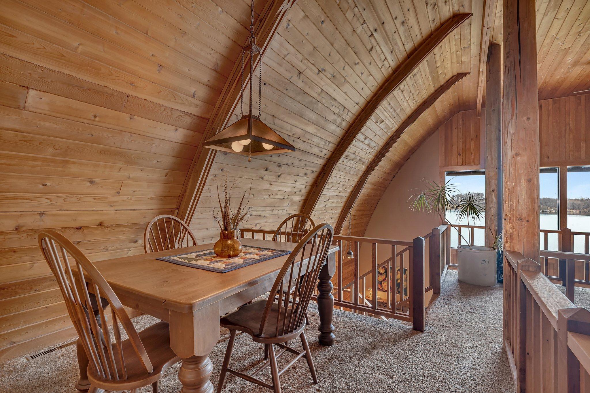 The charming loft space features vaulted, wood ceilings with elegant curved beams.