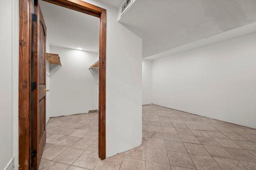 Lowest level walk in closet with bonus room (attached to 5th bedroom). Trim still needed.