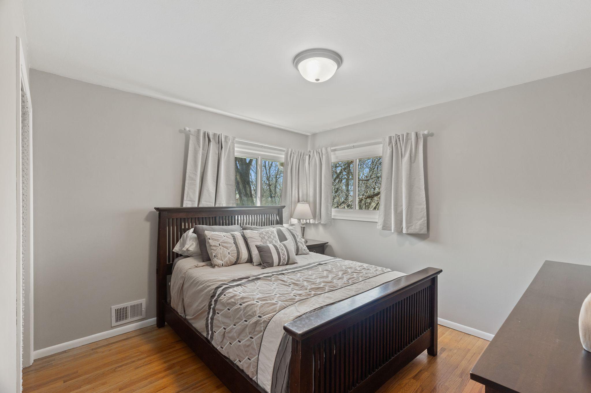Primary bedroom on upper level. Lots of natural light and beautiful hardwood floors