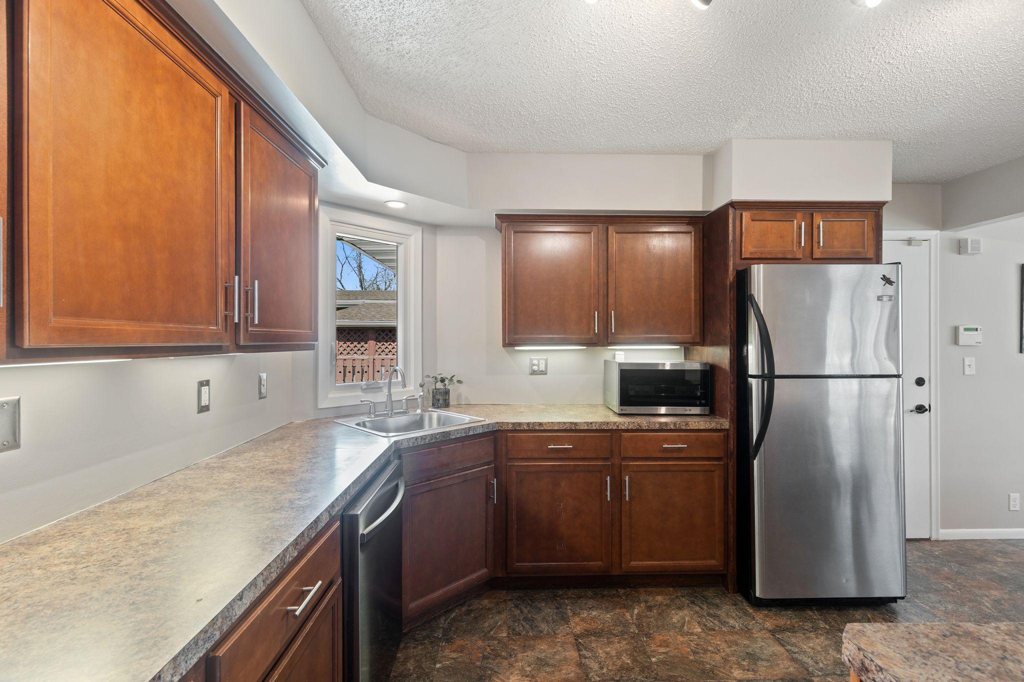 Kitchen with window looking out to the private wooded backyard