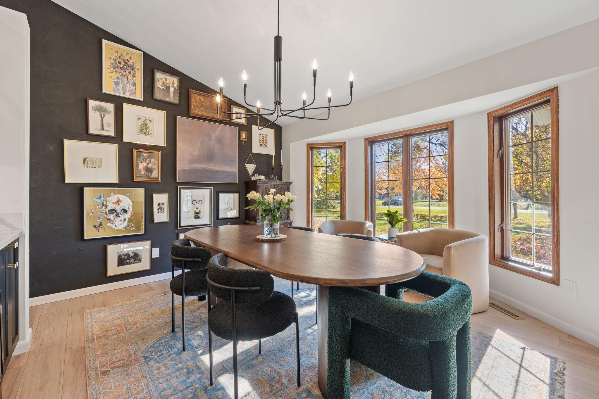 Front dining room includes butlers pantry, LVP wood floors, modern light fixture and plenty of natural light.