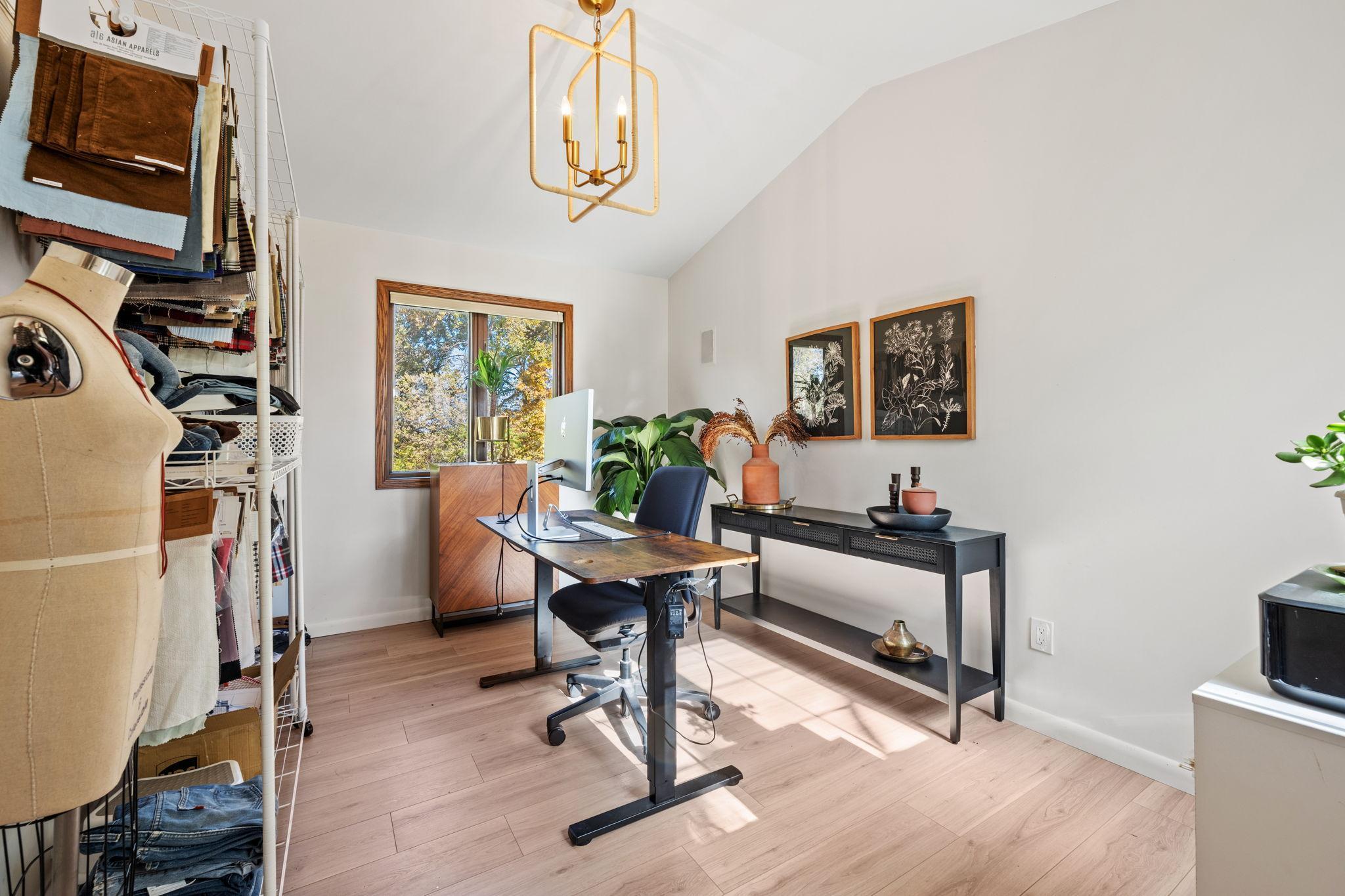 Main floor office is tucked behind the kitchen and front dining room with a view of the river.