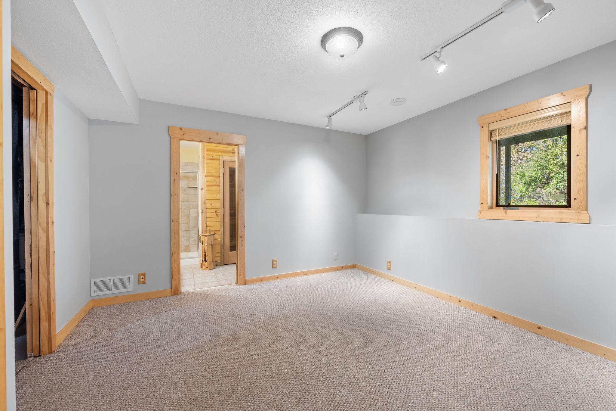 Lower level bedroom adjacent to the sauna.