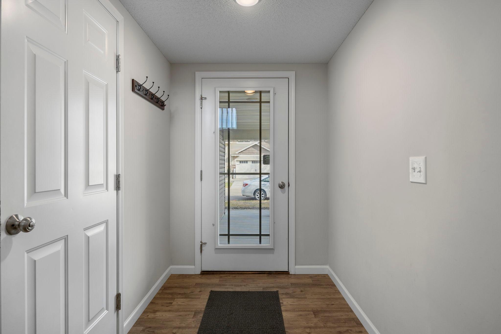 Inside, the foyer features a convenient closet and coat rack