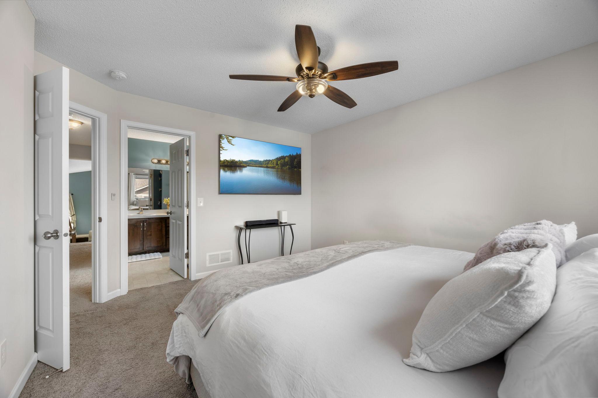 Upper level primary bedroom features a private ensuite bath