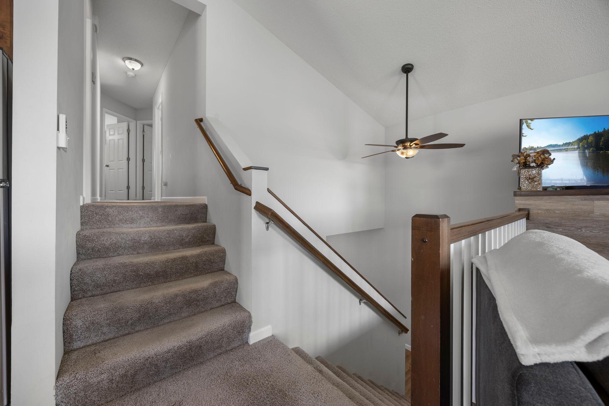 Stairs lead to the upper level, providing privacy for the bedrooms