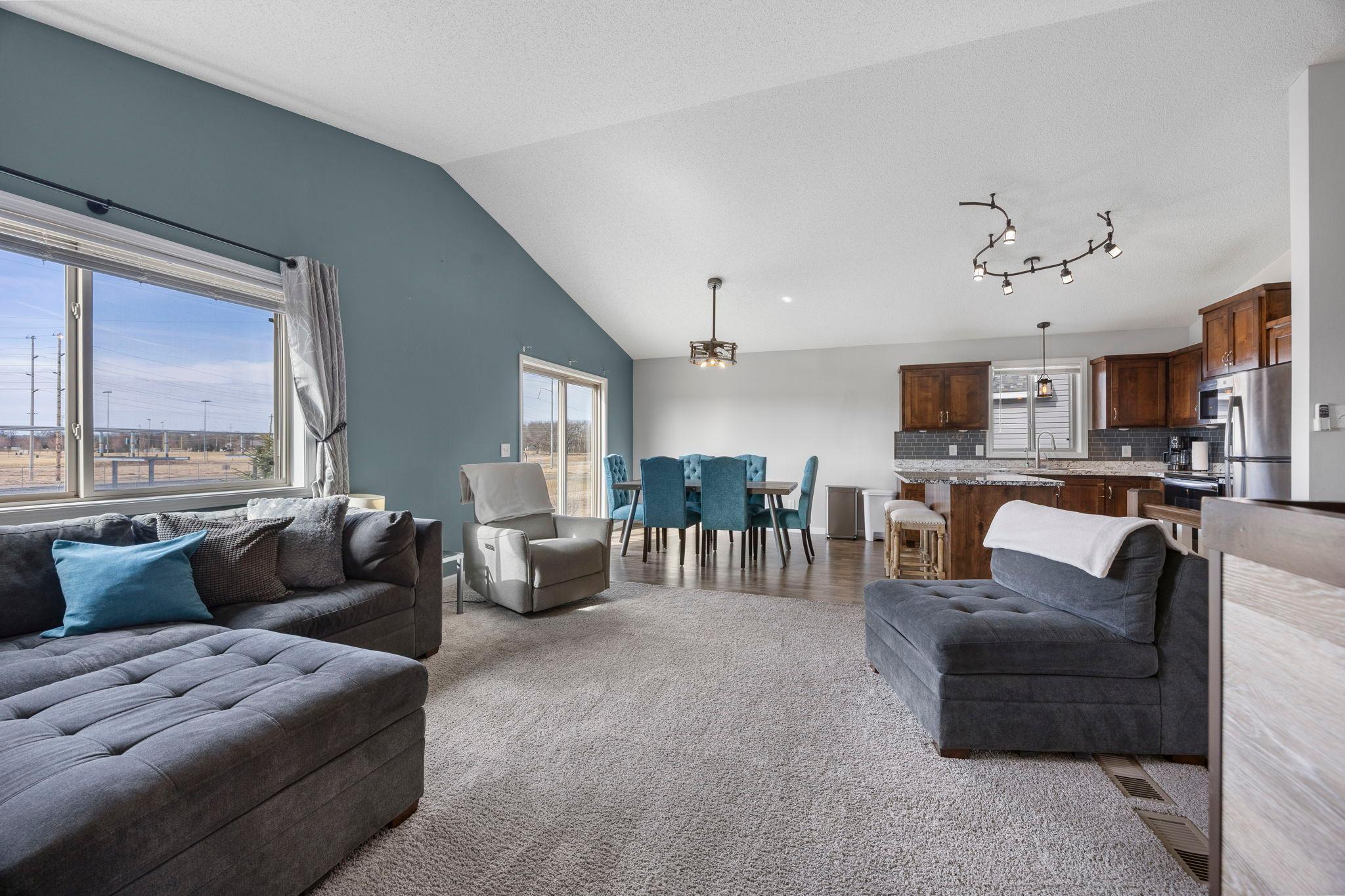 The living room flows seamlessly into the kitchen and dining space