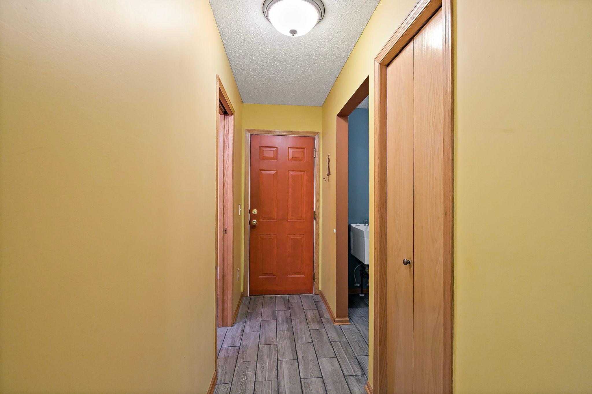 Convenient back hall with access to the half bath, laundry area, and garage entrance for added everyday functionality.