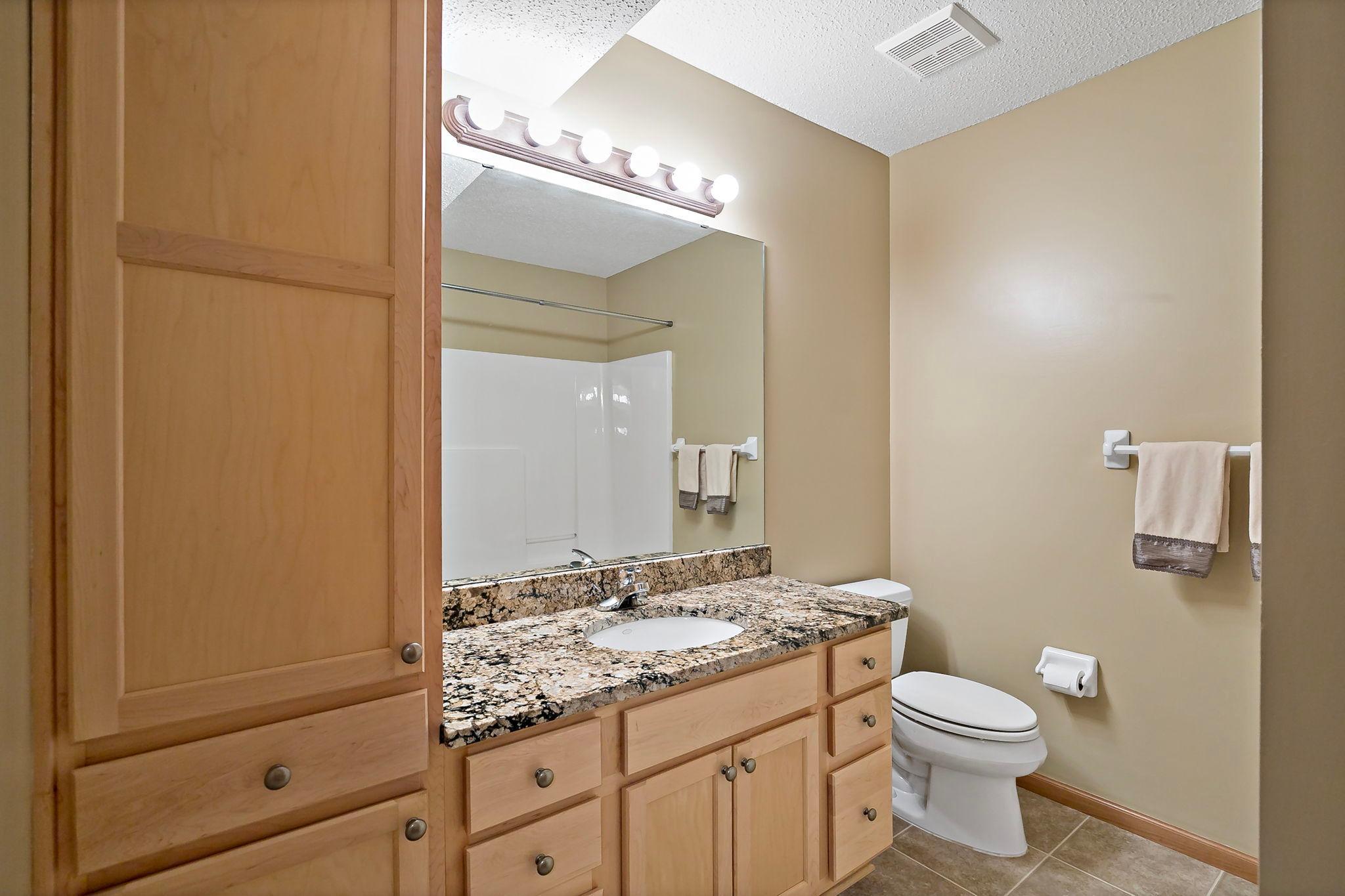 Lower level full bath featuring a well-maintained tub that still shines like new, offering a clean, comfortable, and move-in-ready feel.