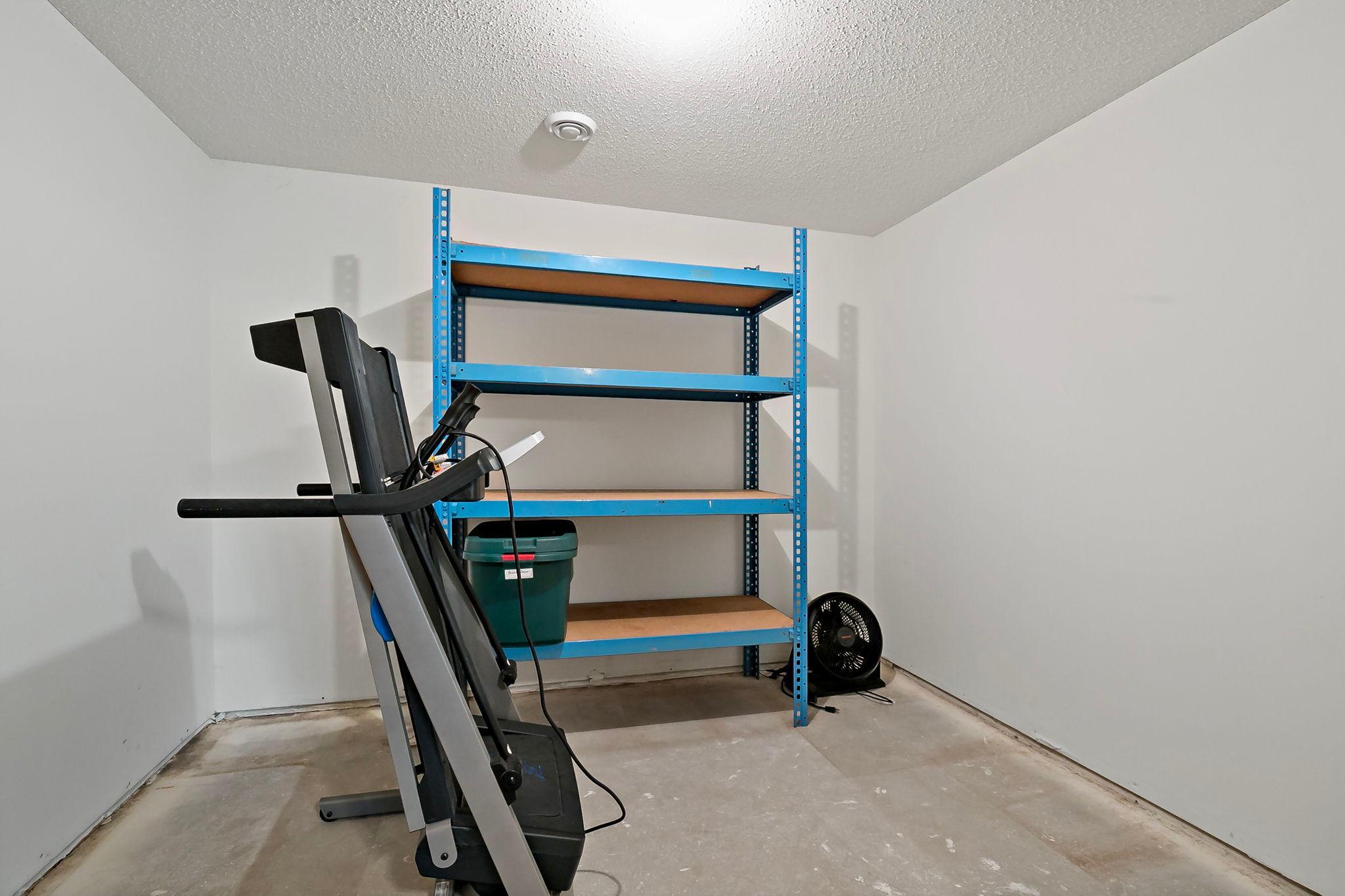 Highly functional storage area featuring including the shelving and even more usable space tucked neatly under the stairs, (not seeable from theis vantage point) providing smart organization options throughout.