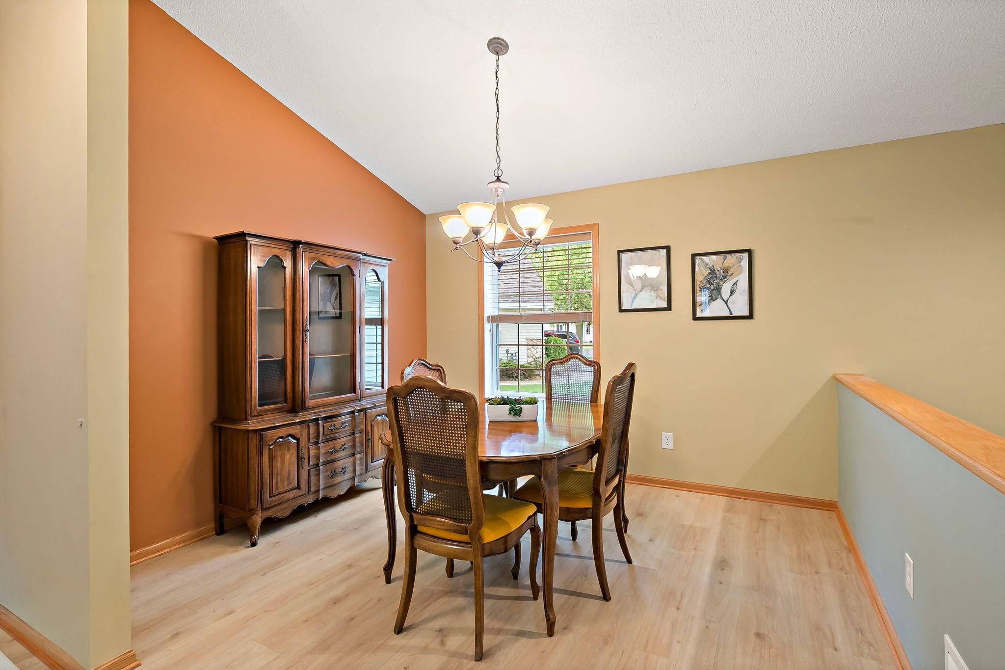 The spacious dining area offers easy access to the kitchen and plenty of room for large groups to gather comfortably around the table.