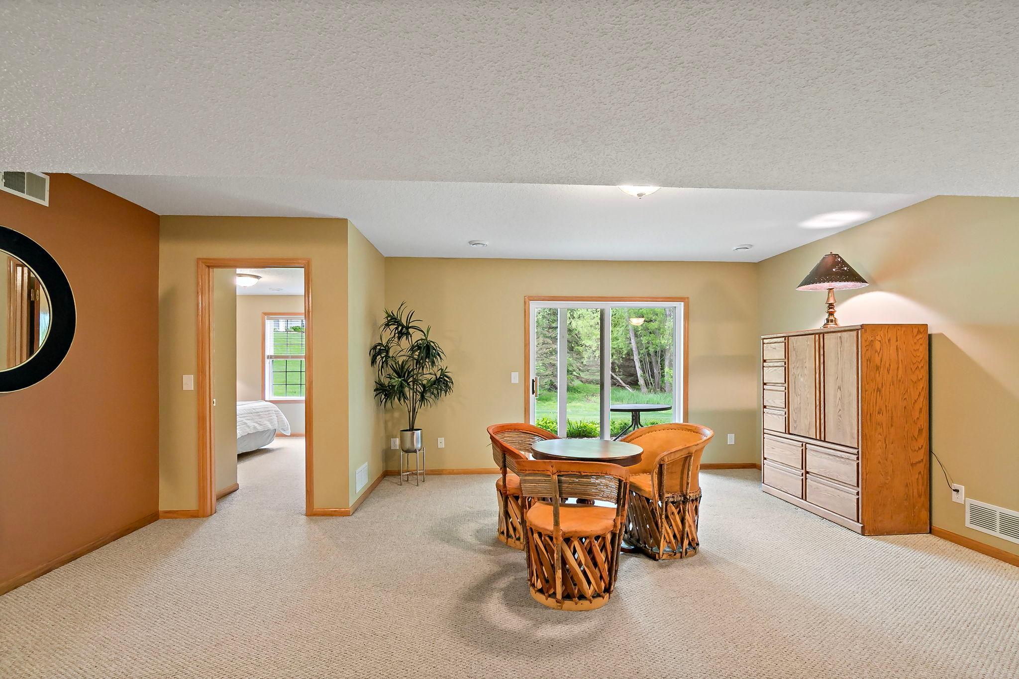 The wow factor shines in this massive walkout lower-level rec and party room, offering an expansive open layout perfect for entertaining, relaxing, and gathering in style.