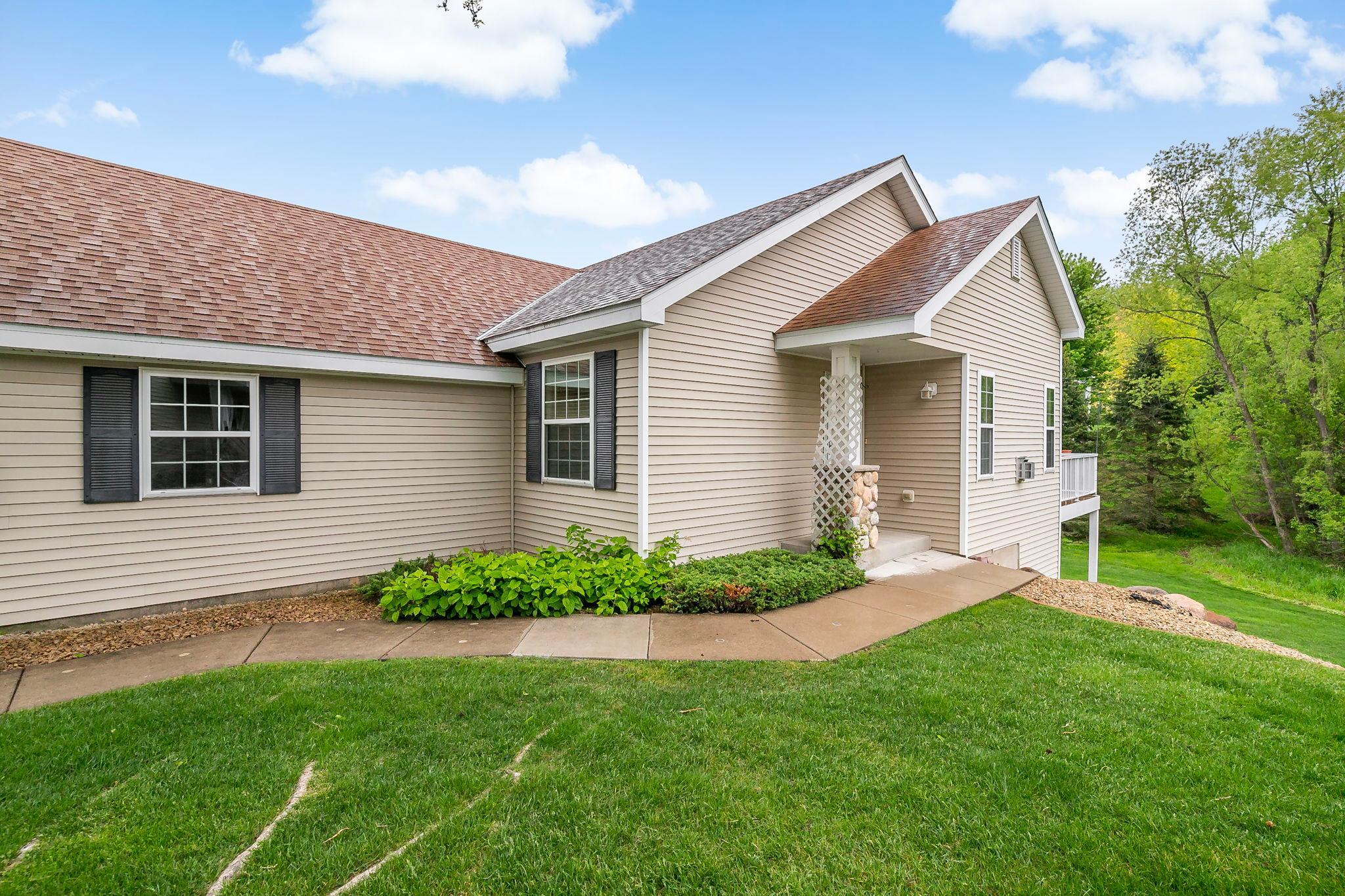 Side view of the home highlighting exceptional privacy, with no neighbors behind or directly on this side of you, creating a peaceful and secluded setting.