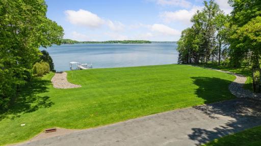 A rare, level lakeshore lot with expansive, panoramic water views—an ideal canvas for a home designed to fully embrace its setting.