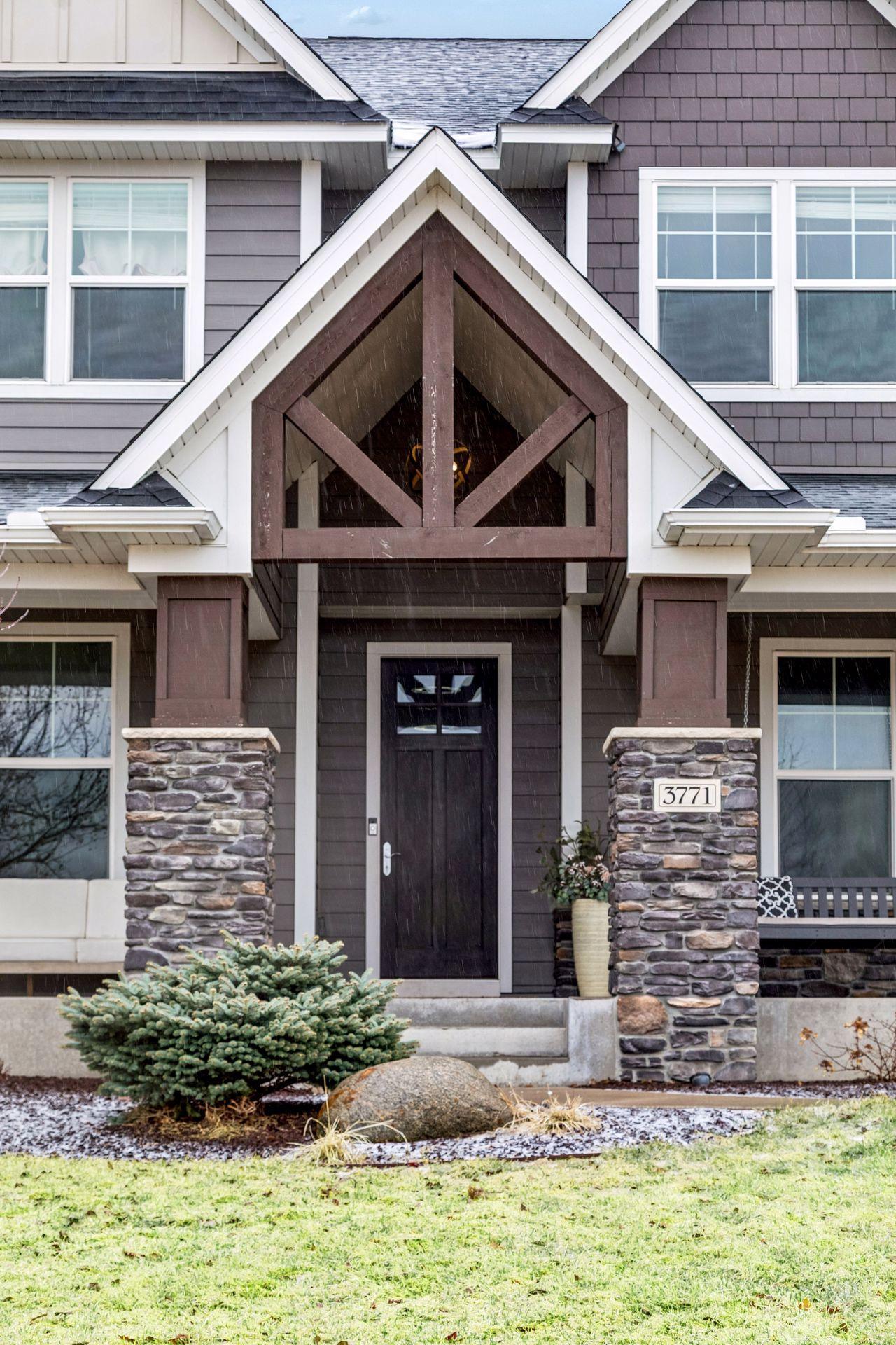 A grand, A-frame covered entry that creates a warm and inviting first impression.