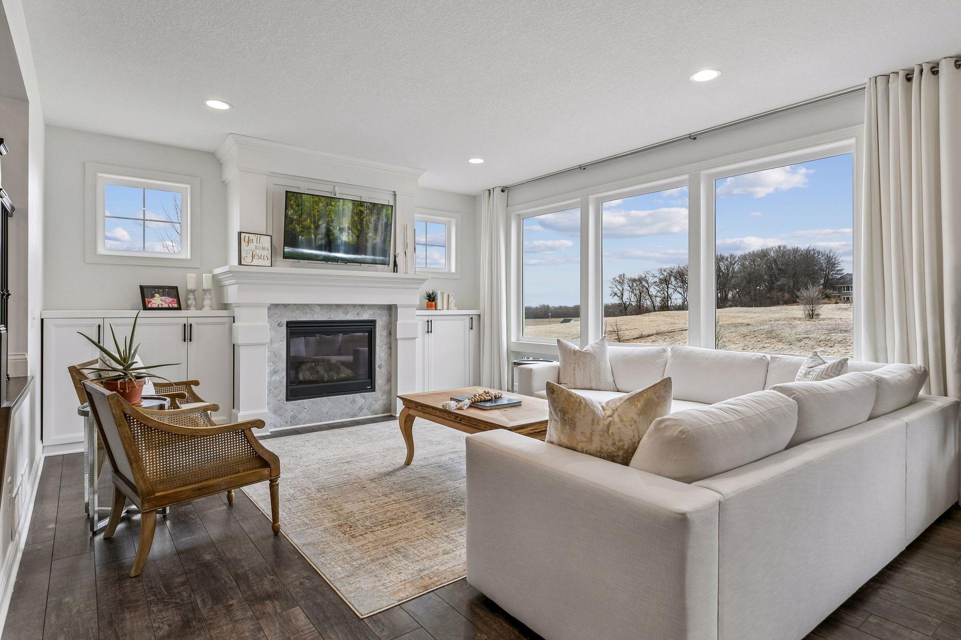 Stone-surround fireplace and walls of windows—this is the heart of the home.