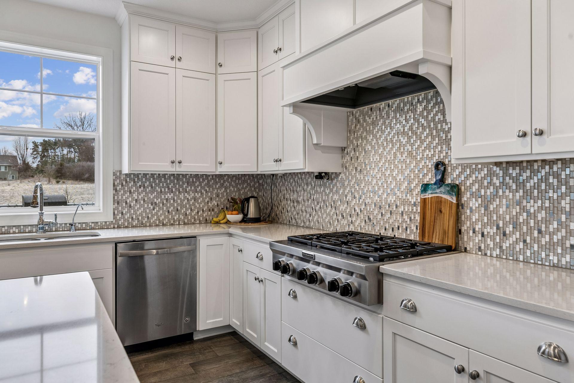 A beautiful backsplash, statement hood, and generous counter space for cooking and gathering.