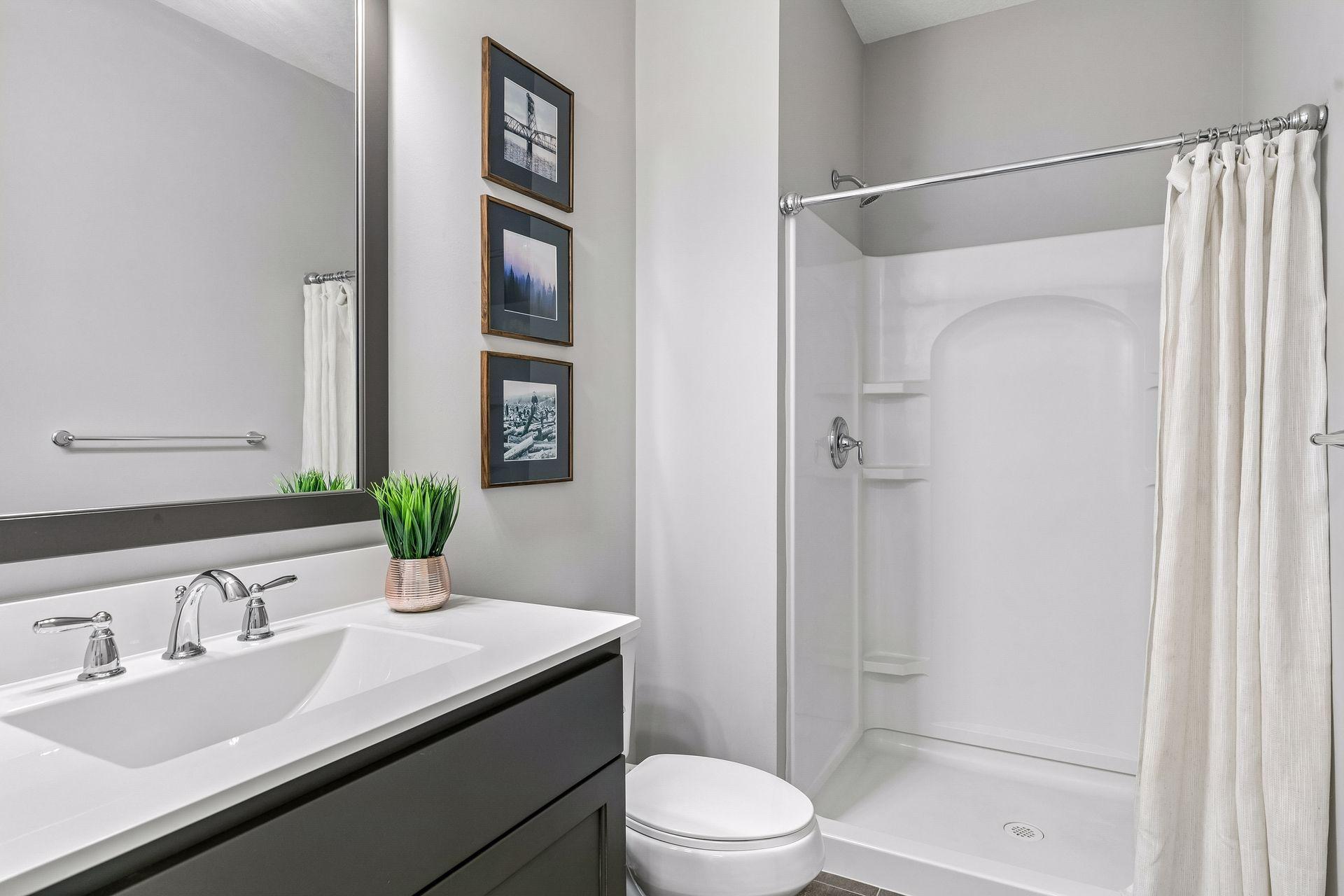 A convenient main floor bath with a walk-in shower—perfect for guests or everyday use.
