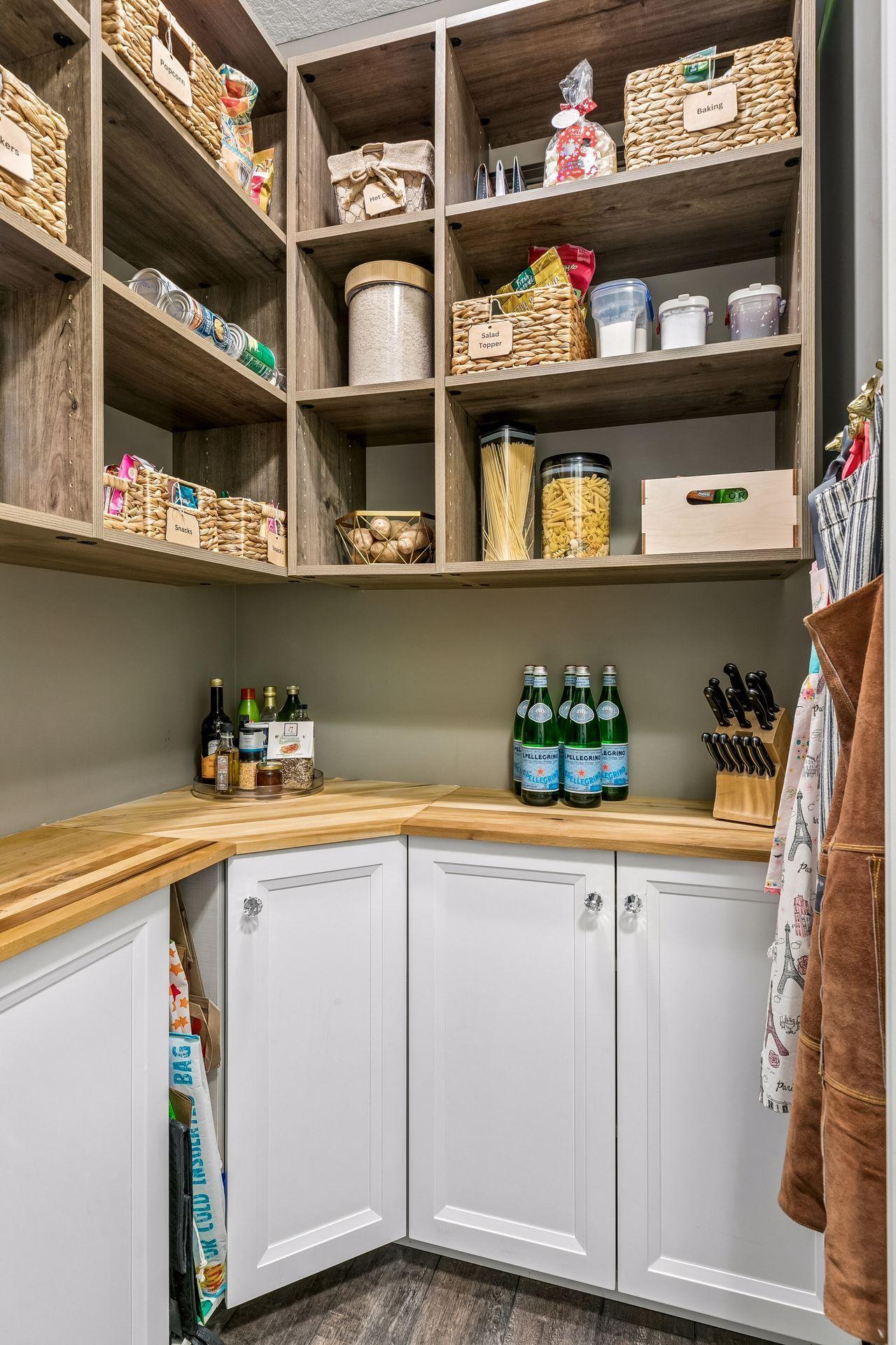 A dream pantry with the perfect blend of hidden storage, open shelving, and space for everyday appliances.