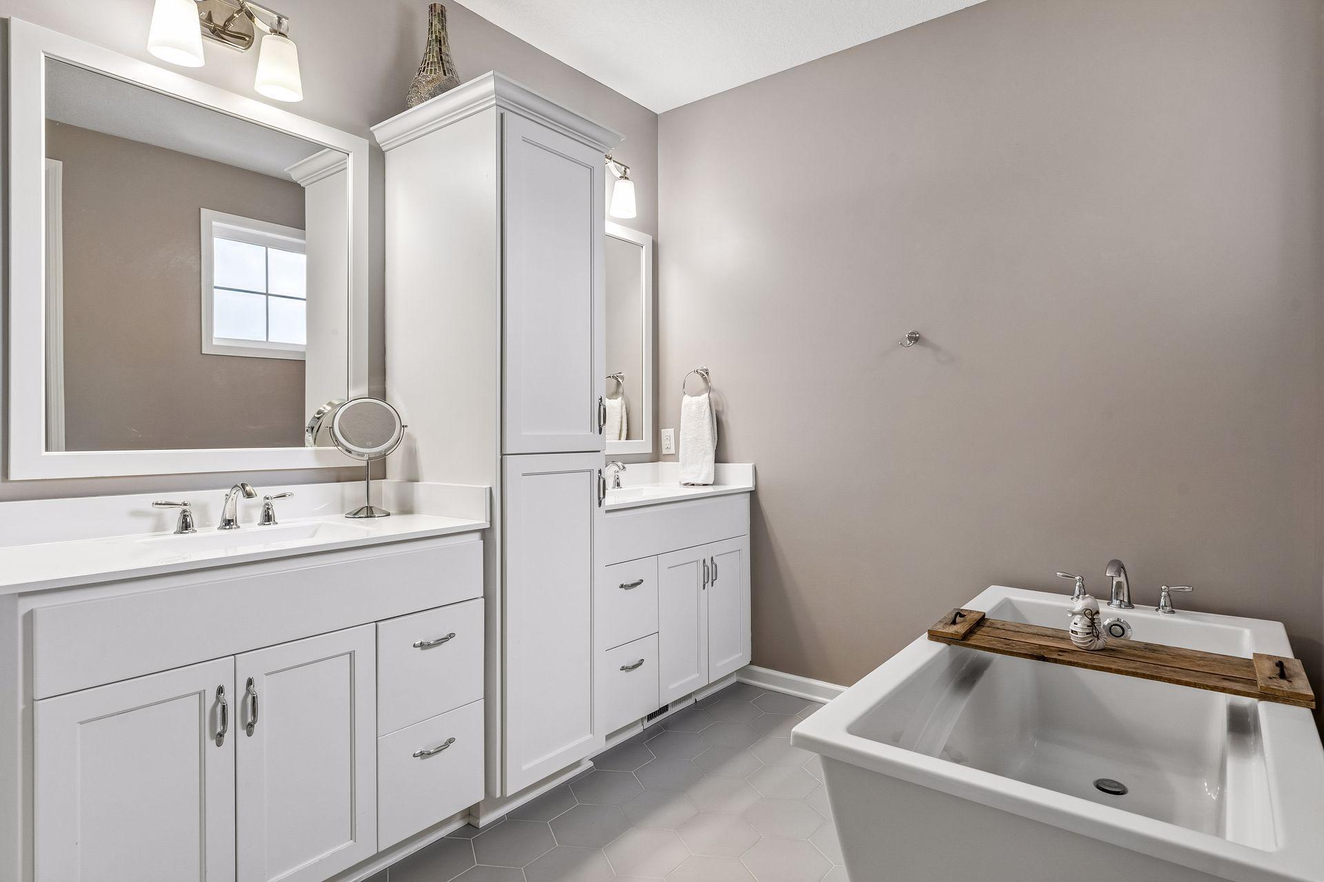 A spa-like ensuite with a soaking tub, dual vanities, and plenty of storage.
