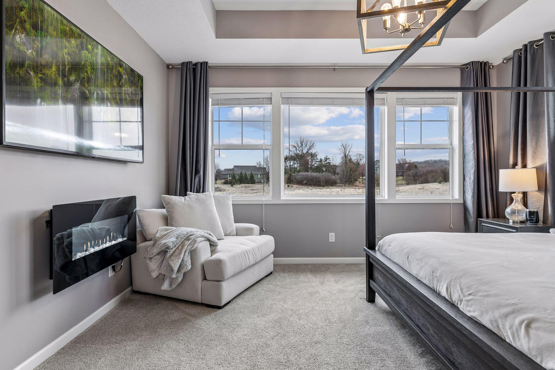 Wake up to peaceful views overlooking the expansive green space behind the home.