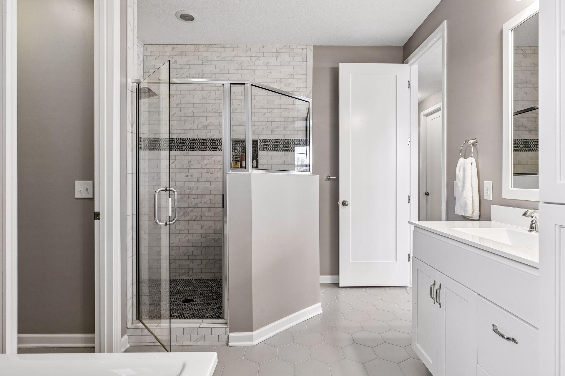 Beautiful stonework creates a clean, timeless feel in the walk-in shower.