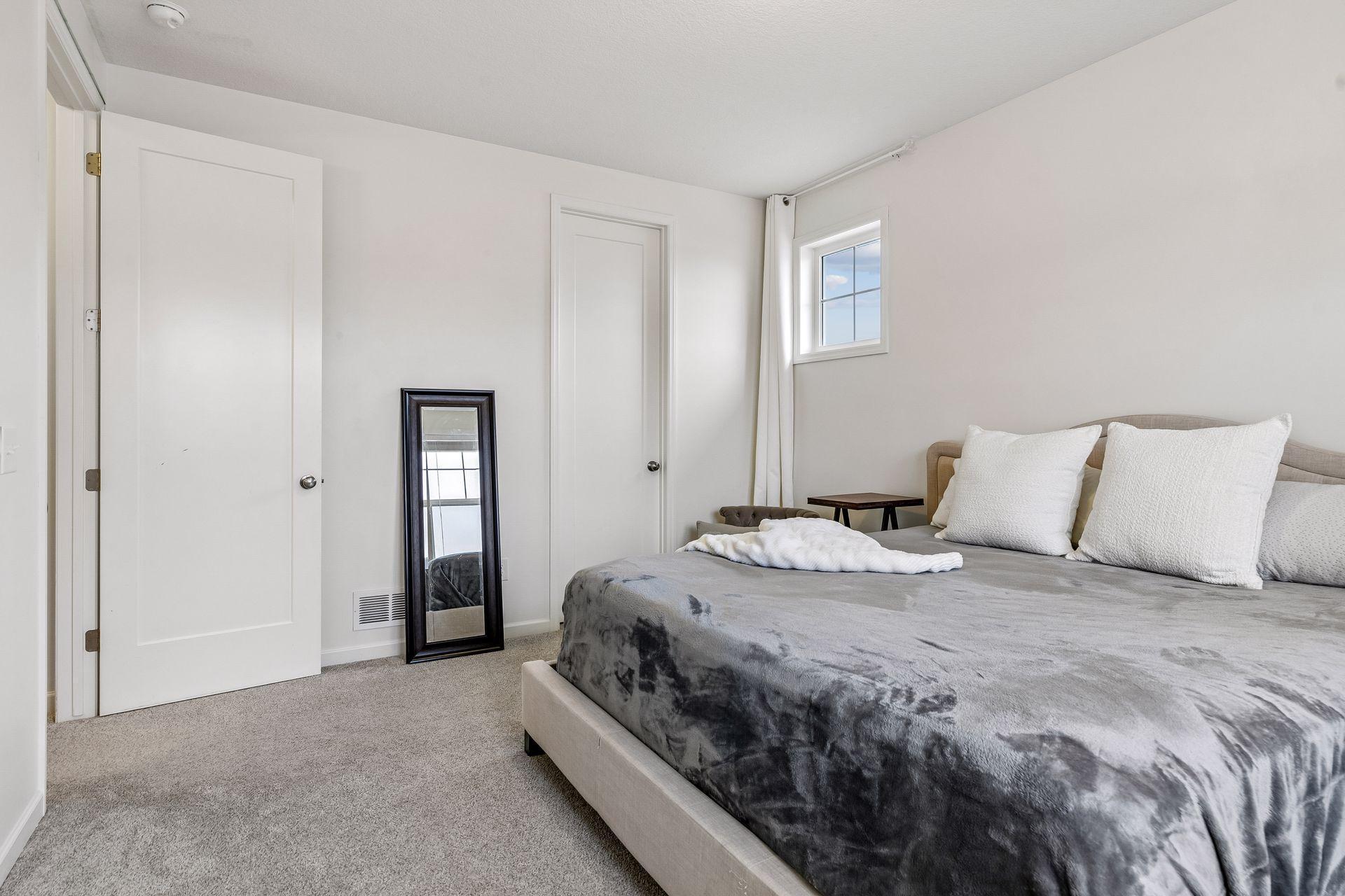 A bright guest room complete with a large walk-in closet.